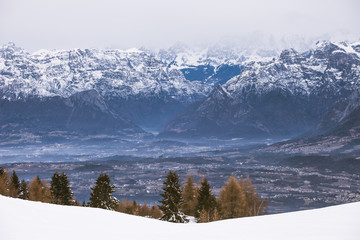 Panorama of dolomite valleys with fogs on a gray day, Belluno, Italy