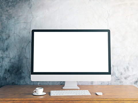 Designer desktop with blank white computer