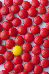 Red color candies and one differet yellow