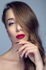 Fototapeta premium Beautiful woman with sexy red lips and fashion color eye makeup.