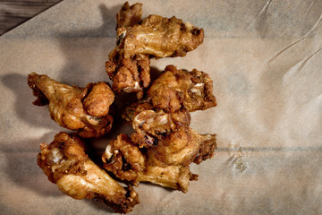 Bbq chicken wings on parchment paper.