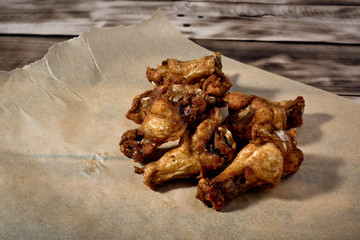 Bbq chicken wings on parchment paper.