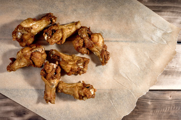 Bbq chicken wings on parchment paper.