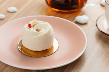 Mini mousse pastry dessert covered with white chocolate velour