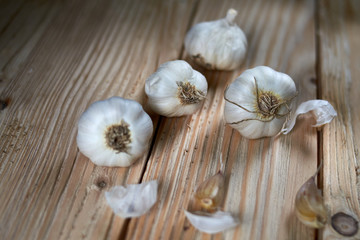 Light wooden background with garlic