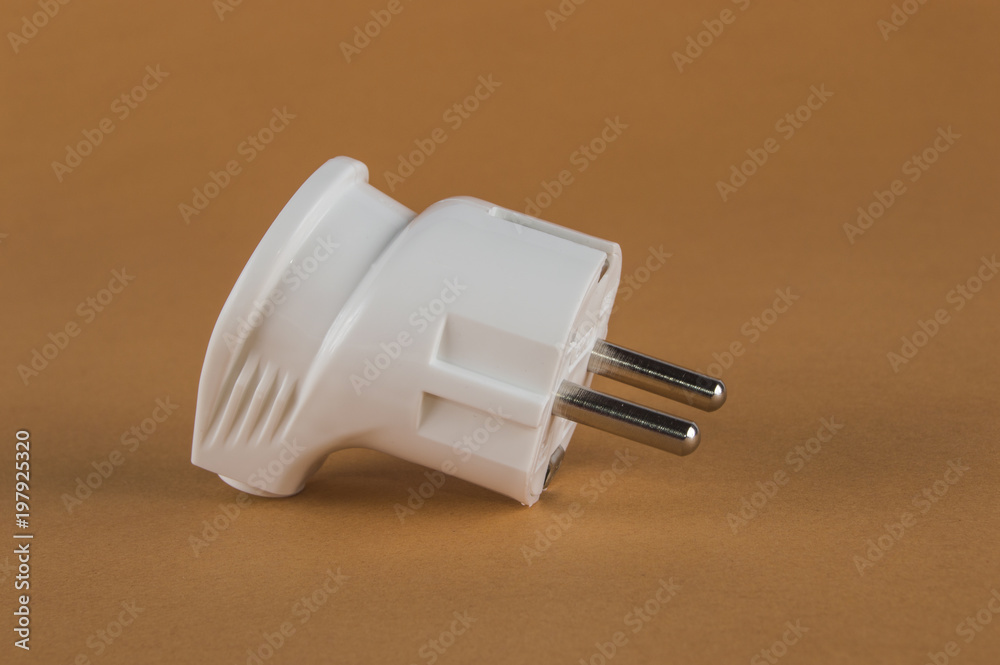 Wall mural white electric plug on an orange background