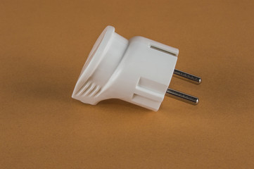 white electric plug on an orange background