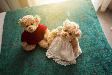 Plush bears sit on the bed in a hotel room