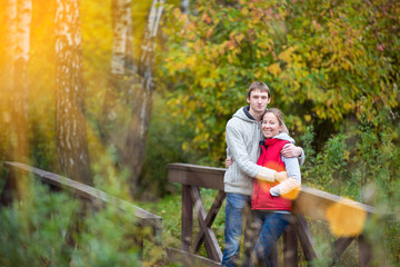 Happy couple walking in the autumn forest