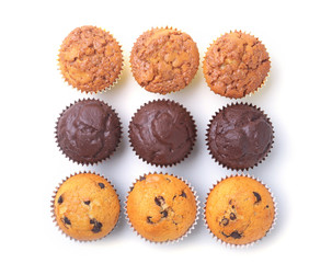 Assorted with Delicious homemade cupcakes with raisins and chocolate isolated on white background. Muffins. Top view.