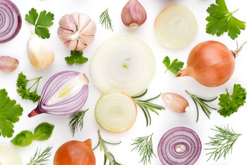 Onion and spices isolated on white background, top view. Wallpaper abstract composition of vegetables.