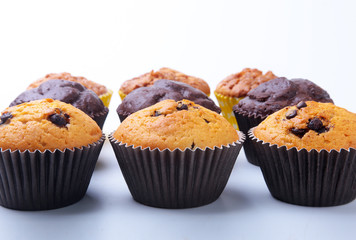 Assorted with Delicious homemade cupcakes with raisins and chocolate isolated on white background. Muffins. Top view.