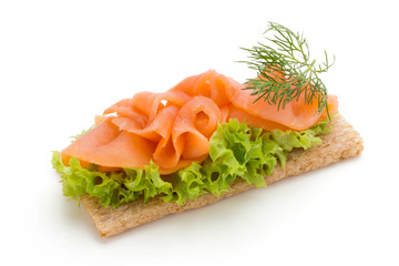 Bread with fresh salmon fillet isolated on white background, top view.