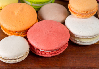 Colorful macaroons on wooden table. Macaroons on old table.
