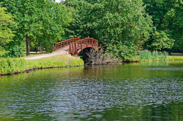 Fototapeta na wymiar Wooden bridge in a public park in Leipzig, Germany