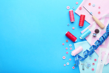 Sewing accessories on blue background