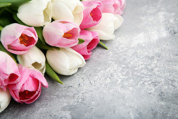 Bouquet of tulips on grey wooden table