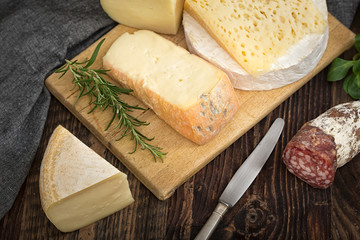 Cheeses with basil, rosemary, tomatoes, grapes and salame.