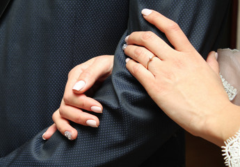 bride holds the groom's hand