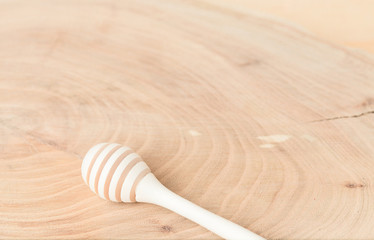Spoon for honey on a wooden background. Element of workpiece for a collage