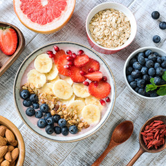 Acai smoothie bowl with banana, strawberries, blueberries and granola, top view, square crop. Healthy eating, healthy lifestyle, dieting, fitness concept
