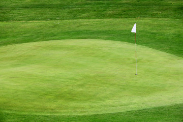 Golf flag on the green grass