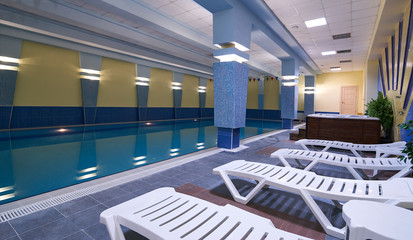 Indoors swimming pool in modern gym fitness spa
