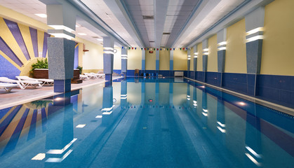Indoors swimming pool in modern gym fitness spa