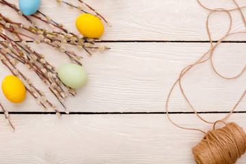 Easter traditional objects isolated on wooden background willow and eggs