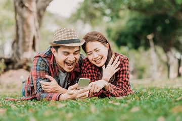 Happy and smile couple looking at smartphone