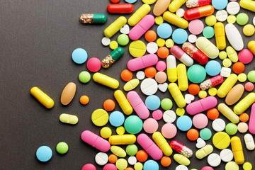 Colorful pills on grey background