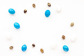 Blue Easter eggs and quail eggs on white background. Flat lay, top view