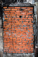 The bricked-up window of an abandoned building