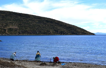 Fototapeta na wymiar Three women working at Titicaca Lake, Bolivia