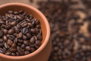 Clay pot filled with coffe beans. Horizontal view