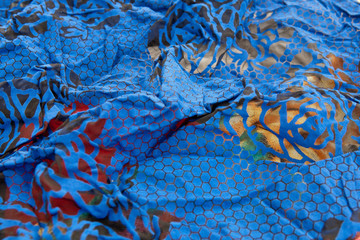 colored crinceld fabric  blue with red  and yellow spot textile background