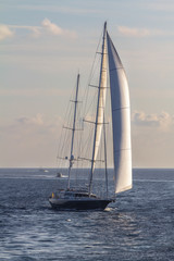 Fototapeta premium Sailboat sailing in the evening