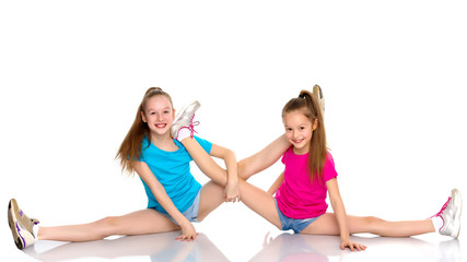 Fototapeta na wymiar Girls gymnasts perform exercises on twine.