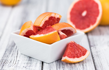 Sliced Grapefruits on an old wooden table (selective focus)