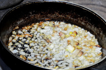 
The chopped onions are fried in oil in a frying pan.