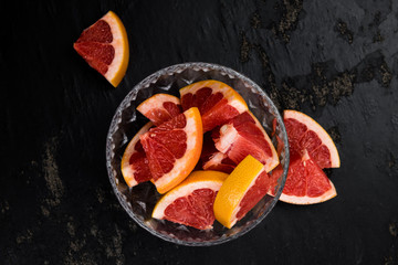 Sliced Grapefruits on a slate slab (selective focus)