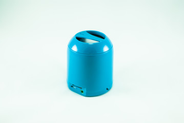Blue mini portable speaker on a white backrground. Isolated