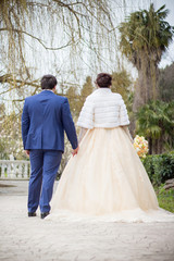 Fototapeta premium The bride and groom are walking in the park