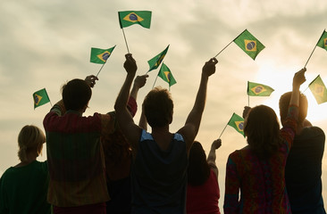 Small brazilian flags. Back view. Evening sky bakground.