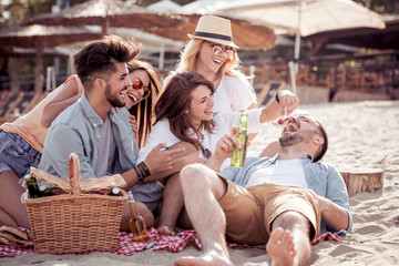 Group of young friends having fun on the beach