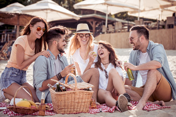 Happy young friends having fun on the beach