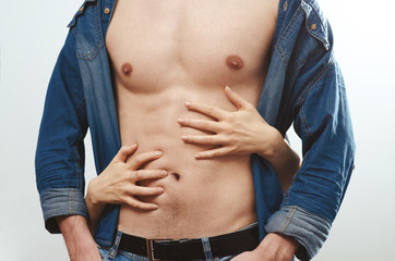 Male chest and female hands touching it