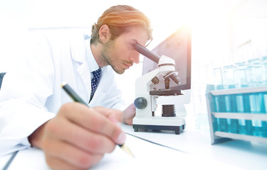 scientist makes a note of experiment in the laboratory