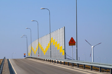 A noise-absorbing barrier also called a soundwall, noise wall, sound berm, noise barrier, sound...