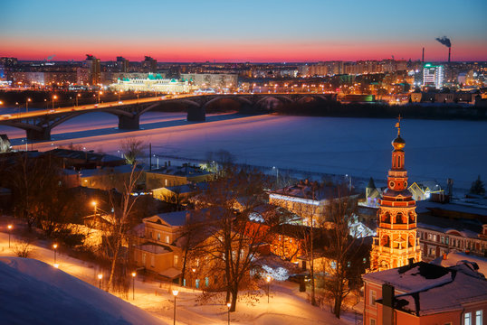 Night dusk cityscape panorama view of Nizhny Novgorod at winter, Russia. Kanavino Bridge over Oka River